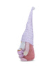 Load image into Gallery viewer, Side angle of the gnome holding hot chocolate. From this perspective, the long hat with a pattern of small pink hearts is very noticeable. The background of the picture is white.
