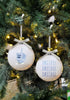 Load image into Gallery viewer, Lifestyle picture of the Hanukkah ornaments. They are hanging on a Christmas tree, directly receiving yellow lights from Christmas bulbs.

