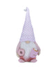 Load image into Gallery viewer, Front angle of the Valentine-themed pink gnome. All the features of the gnome are fully appreciated from this angle: the cup of hot chocolate held in its left hand, the doughnut in its right hand, and the harmonious blend of its pink shades. Lastly, the background of the photo is white.
