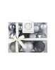 Load image into Gallery viewer, Front angle of the package with the black-silver tree ornaments. This package is transparent, permitting to see the ornaments within. It is adorned with a white ribbon that have gold-colored borders.
