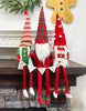 Load image into Gallery viewer, Lifestyle picture of the sitting gnomes. The gnomes are placed on the end of a wooden mantelpiece. The long legs make the gnomes to look like floating, something that is appreciated in this photo.
