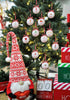 Load image into Gallery viewer, Lifestyle picture of the set of 12 Christmas ornaments with symbols on it. They are hanging on a Christmas tree with lighting bulbs on it. In front of the tree, there&#39;s a red and white Christmas gnome that holds a red decorative heart. There are also three decorative red, white, and green Christmas boxes on the right side, one above the other. Next to the boxes, there&#39;s a decorative calendar with the term &quot;Days &#39;Till Christmas&quot; on it.
