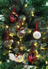 Load image into Gallery viewer, Lifestyle picture of the set of 6 Christmas ornaments with words on it. They are hanging on a Christmas tree with lighting bulbs on it. The light is reflected on the ornaments, giving it a shining effect.
