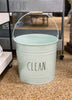 Load image into Gallery viewer, Lifestyle picture of the metal mop bucket. Standing in a gravel-covered floor, the bucket is positioned in a frontal angle.
