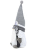 Load image into Gallery viewer, Side angle of the snowboarder gnome. From this angle, it can be fully appreciated the black snowboard with glittered decorative snowflakes that the gnome is holding. 
