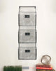 Load image into Gallery viewer, Lifestyle image of the 3-tier vintage file holder hanging on a white wall. Decorative books are placed below it on the bottom right, with a small stack of fake grass on the bottom left.
