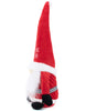 Load image into Gallery viewer, Side angle of the plush Santa gnome. In this angle, it is more noticeable the belt that this gnome wears. It can be fully appreciated that this belt has a black and white checkered design.
