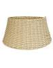 Load image into Gallery viewer, Front-angle picture of the woven tree ring. All its features can be appreciated in this photo: the tapered, circular shape; its khaki color; the rattan material; and its woven texture. The background of the image is white.
