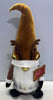 Load image into Gallery viewer, Lifestyle picture of the reindeer gnome, placed in a frontal angle. The gnome stands on a white surface, having a gray wall behind. 
