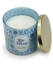 Load image into Gallery viewer, High angle view of the candle with a romance-related scent. All elements of the candle are visible, with the top part being more prominent in this perspective. The lid is not placed on top; instead, it rests vertically next to the candle on the jar. The white wax and the two wicks of the candle are visible and appreciated.
