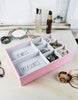 Load image into Gallery viewer, Lifestyle picture of the two jewelry trays, positioned one above the other on a white marble-like surface. Jewelry pieces are placed in the smaller sections, serving as examples of the types of items the trays can hold.
