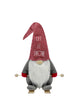 Load image into Gallery viewer, Front angle of the Ski gnome. In this angle, it can be easily read the term &quot;Let it Snow&quot; on its hat.
