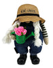 Load image into Gallery viewer, Front angle of the spring-themed gnome. From this perspective, its main features can be fully appreciated: The green watering can with the term &quot;#1 Mom&quot; on it, the wide white braids, its sun hat with the term &quot;Mom&#39;s Garden,&quot; and the denim blue overall. The background of the picture is white.
