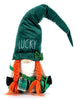 Load image into Gallery viewer, Front angle view of the St. Patrick&#39;s Day-themed gnome. In this perspective, the gnome&#39;s main features can be fully appreciated: the long green hat adorned with the term &quot;Lucky,&quot; the orange braids, the green skirt with a tartan design, as well as the white sweater the gnome is wearing. The background of the picture is white.
