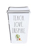 Load image into Gallery viewer, Front view of the desk sign for teachers. It is placed in a standing position. From this angle, its main features can be appreciated: the disposable coffee cup shape, the phrase &quot;Teach. Love. Inspire&quot; written on it in the Rae Dunn font, illustrations of a globe, an apple, and a ruler on the bottom part, and thick black cartoon lines drawn on the edges of the sign. Lastly, the background of the picture is white.
