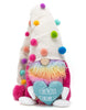 Load image into Gallery viewer, Front angle of the gnome. The multicolor feature of this piece can be fully appreciated from this angle. Its colorful felted balls, beard, and the contrast with its fuchsia sweater grab attention with their vibrant brightness. The background of the picture is white.
